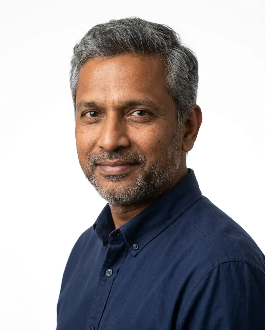 Portrait of a man in his forties with a salt-and-pepper hair system